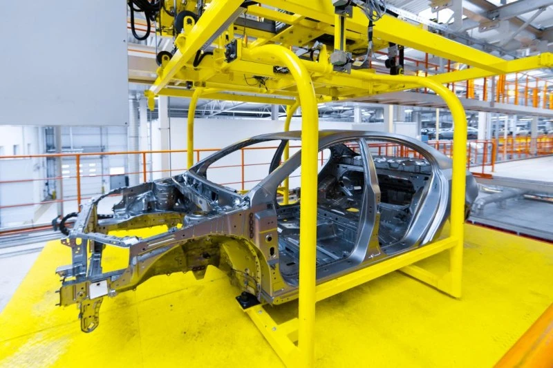 A structural cross-car beam located behind the dashboard A structural cross-car beam located behind the dashboard